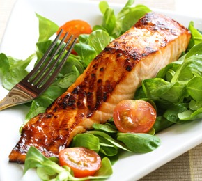 Grilled salmon with a honey glaze on a bed of lambs lettuce